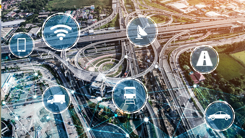 Aerial view of a highway with digital overlays showing smart transportation systems
